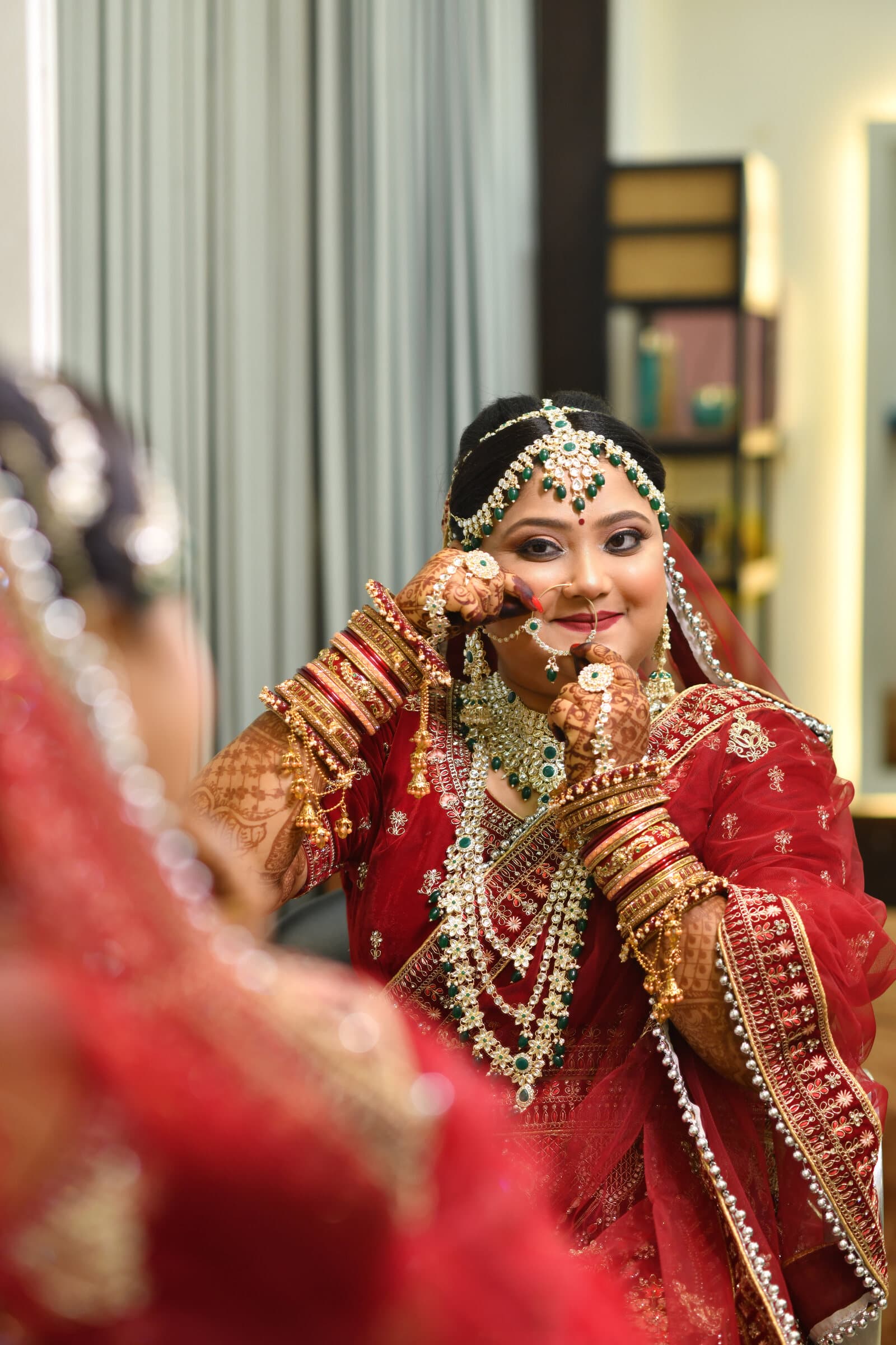 Bride in red bridal wear, close portrait with jewelry detail